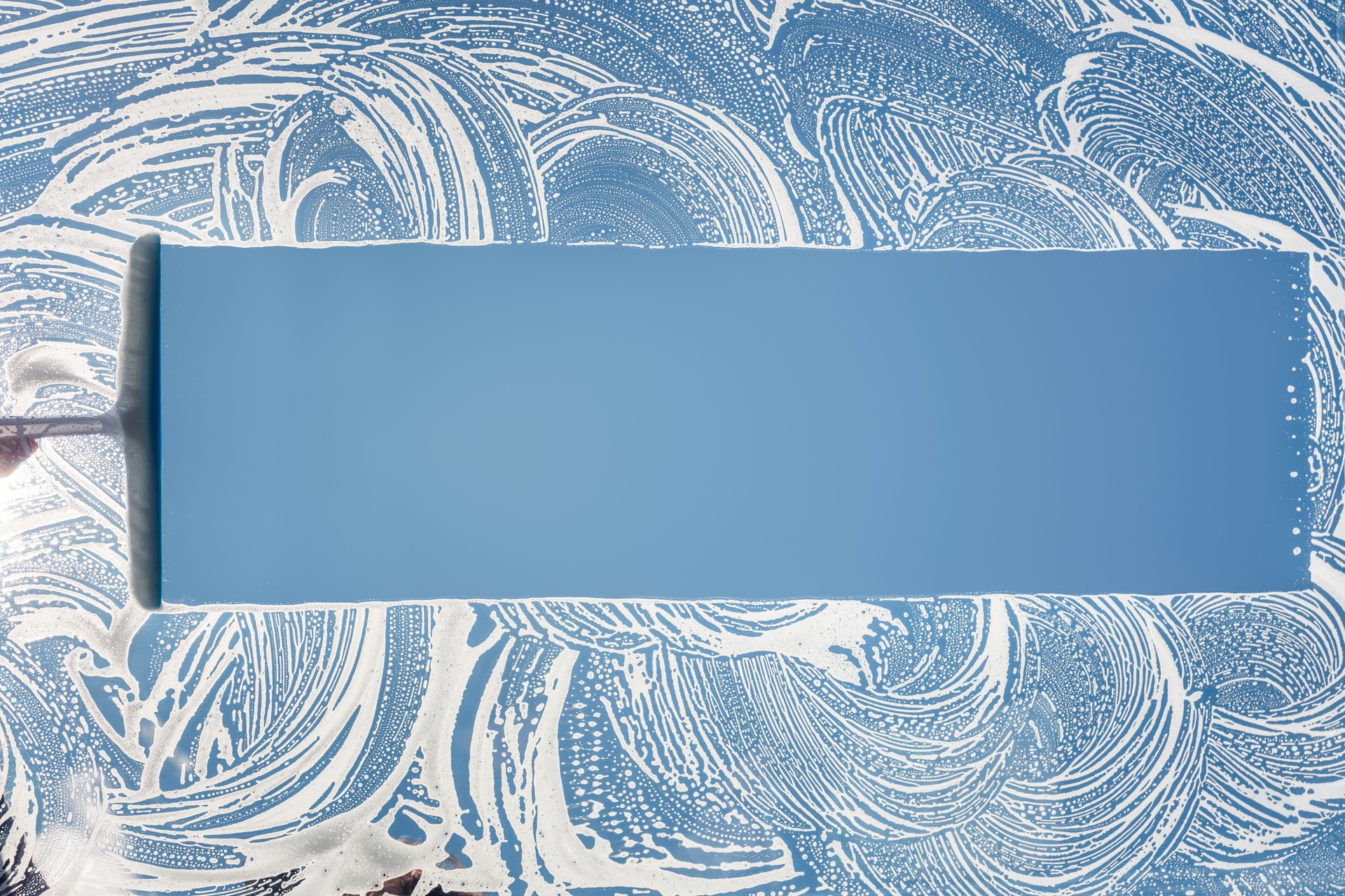 Window cleaner using a squeegee to wash and clean a window Window cleaner using a squeegee to wash and clean a window